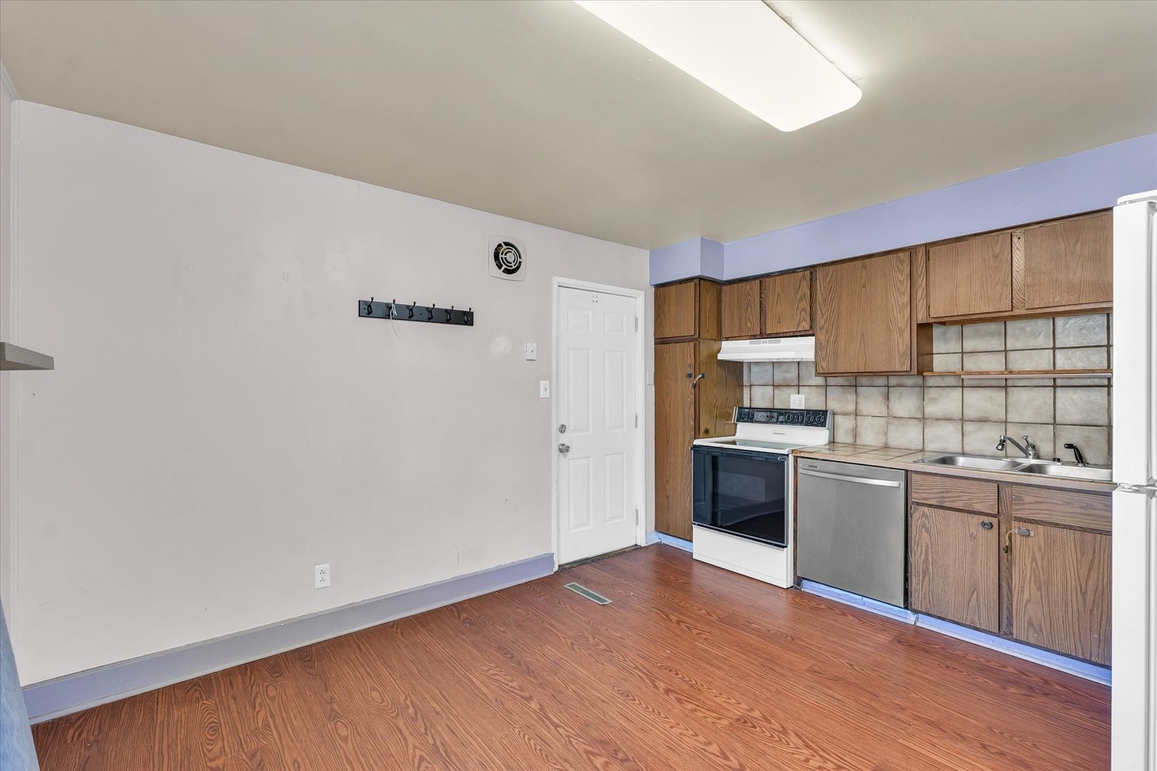1710 Parkside Terrace Champaign, IL 61821 - Photo 9 of 31 a kitchen with a white cabinets and wooden floor
