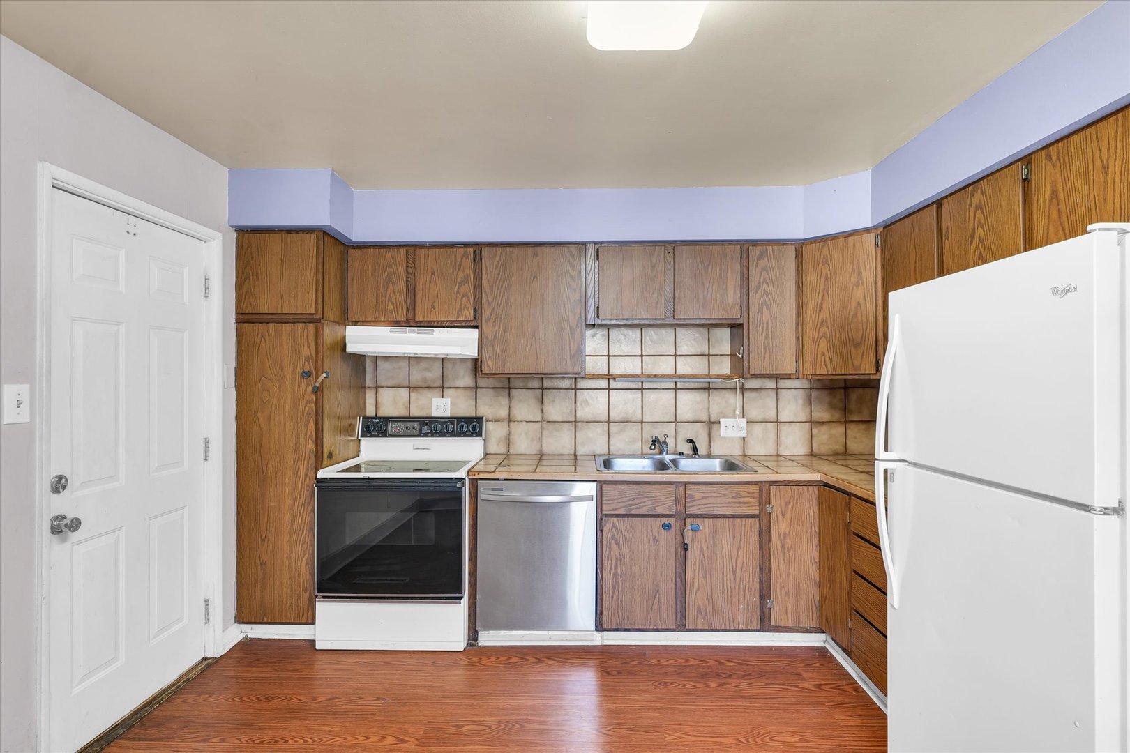 1710 Parkside Terrace Champaign, IL 61821 - Photo 10 of 31 a kitchen with a sink a refrigerator and cabinets