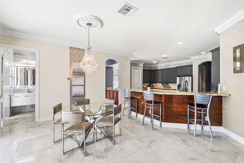 a large kitchen with stainless steel appliances granite countertop a sink stove and cabinets