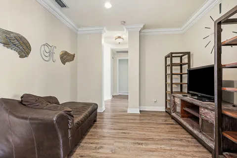 a spacious bedroom with a bed a table and a large window