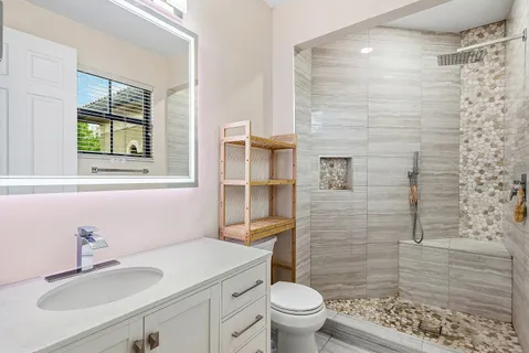 a bathroom with a sink toilet and shower