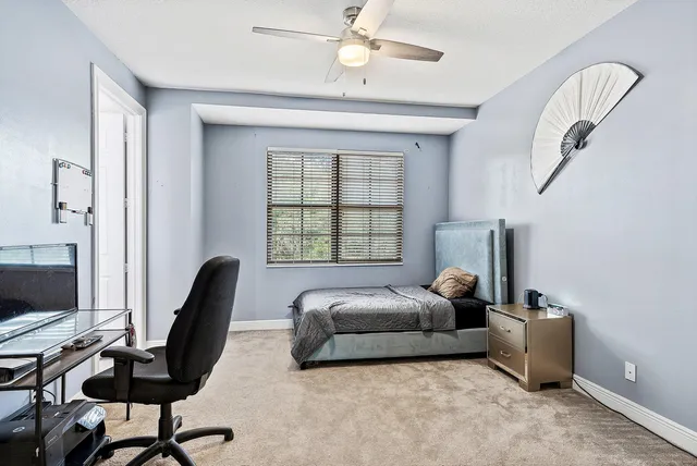 a front view of a house with a yard and palm tree