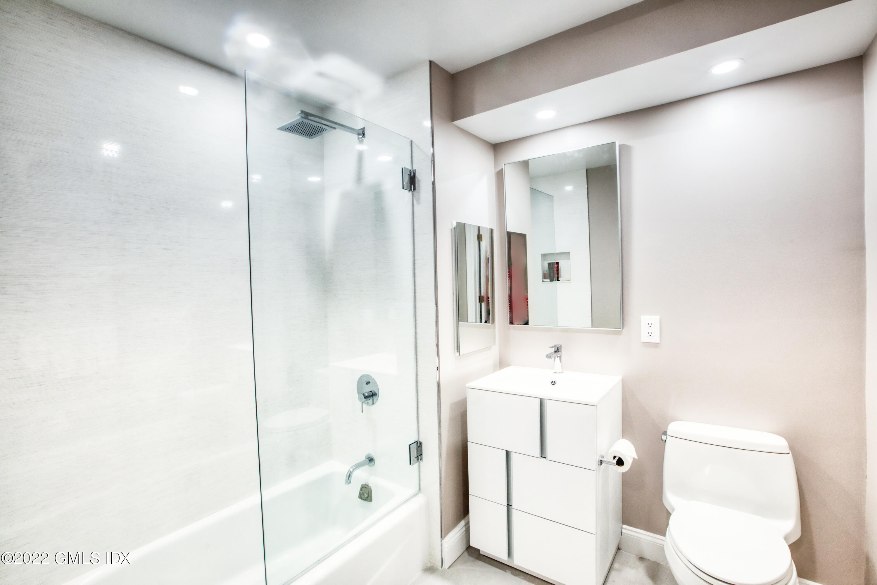 2 Homestead Lane, Unit 106 Greenwich, CT 06831 - Photo 13 of 25 a bathroom with a sink toilet tub and shower