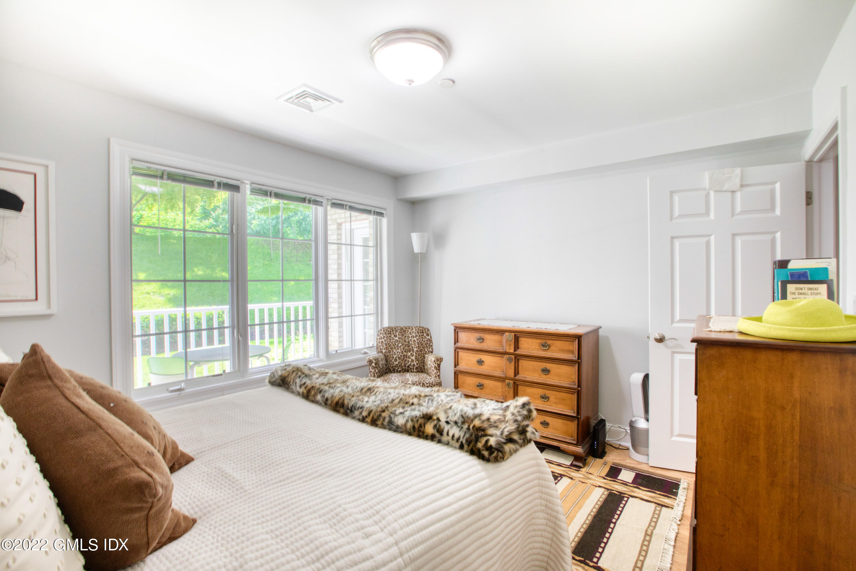 2 Homestead Lane, Unit 106 Greenwich, CT 06831 - Photo 15 of 25 a bedroom with a bed and a window