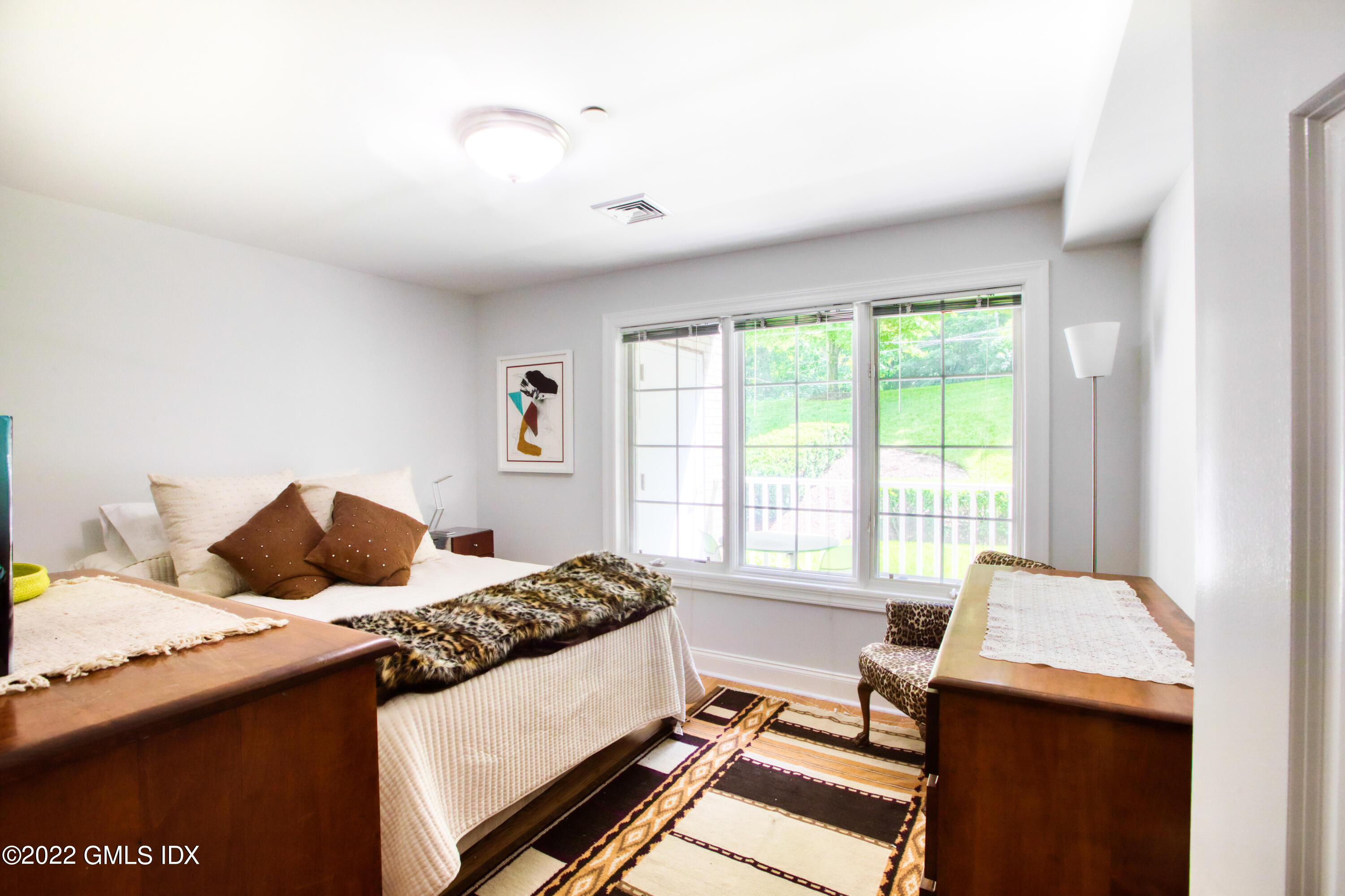 2 Homestead Lane, Unit 106 Greenwich, CT 06831 - Photo 16 of 25 a bedroom with a bed and a window