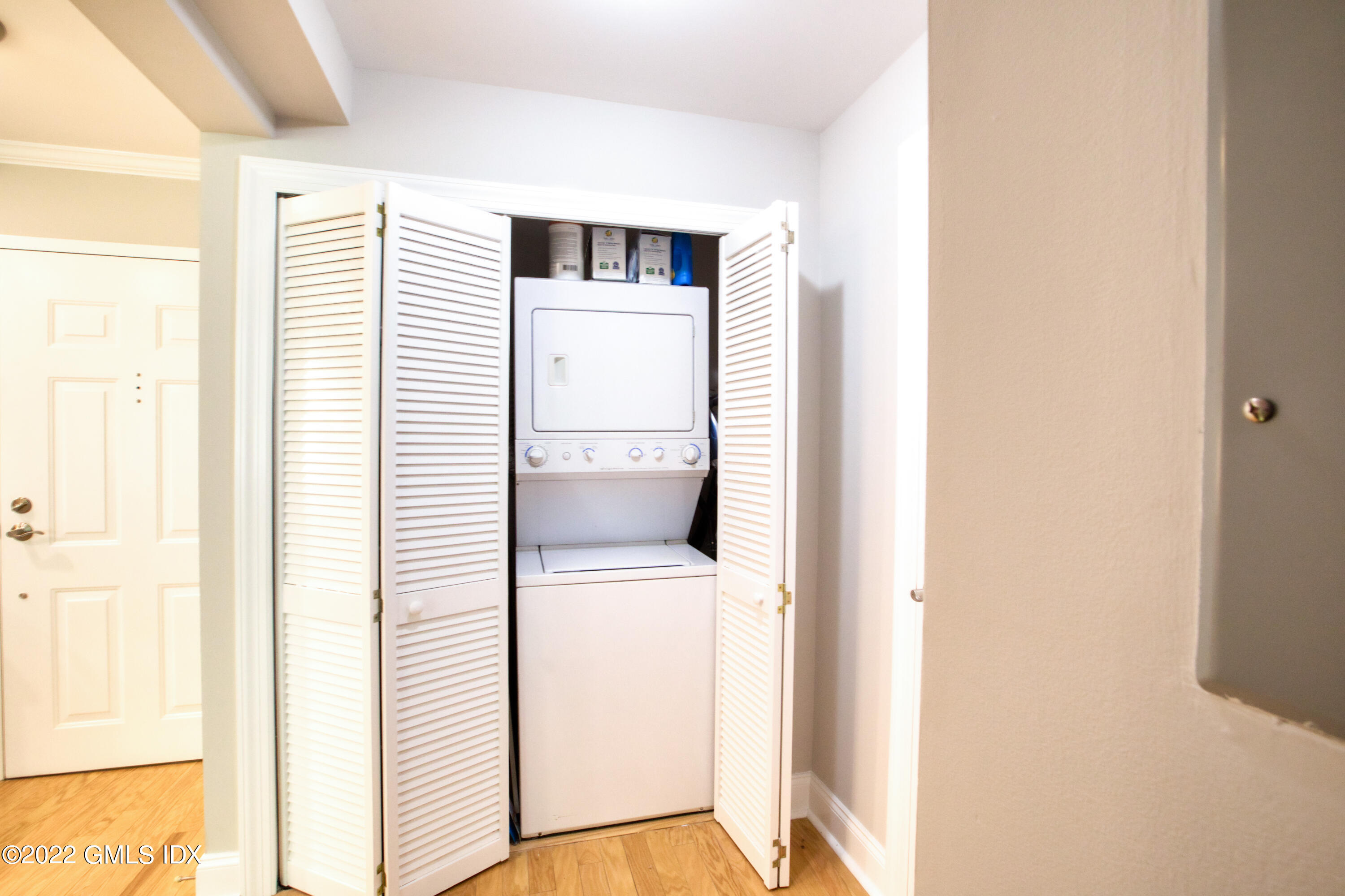 2 Homestead Lane, Unit 106 Greenwich, CT 06831 - Photo 18 of 25 a view of a hallway with a bathroom and a window