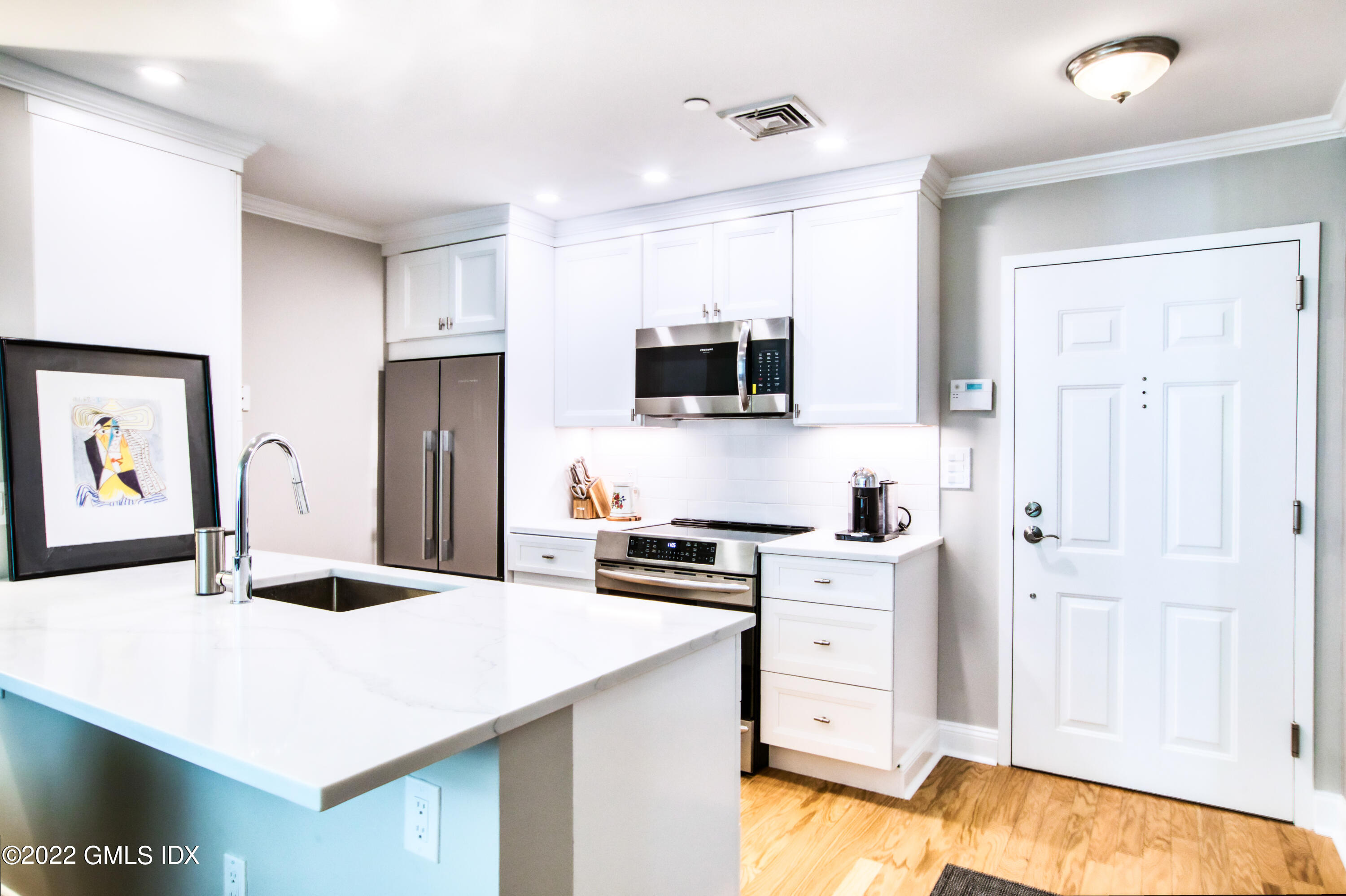 2 Homestead Lane, Unit 106 Greenwich, CT 06831 - Photo 3 of 25 a kitchen with stainless steel appliances a stove refrigerator sink and cabinets