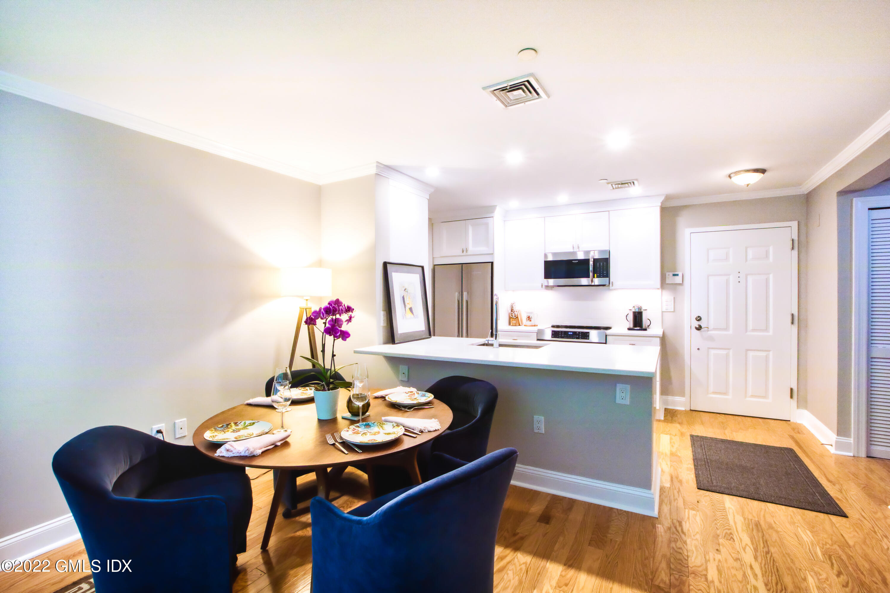 2 Homestead Lane, Unit 106 Greenwich, CT 06831 - Photo 5 of 25 a view of a dining room with furniture and wooden floor