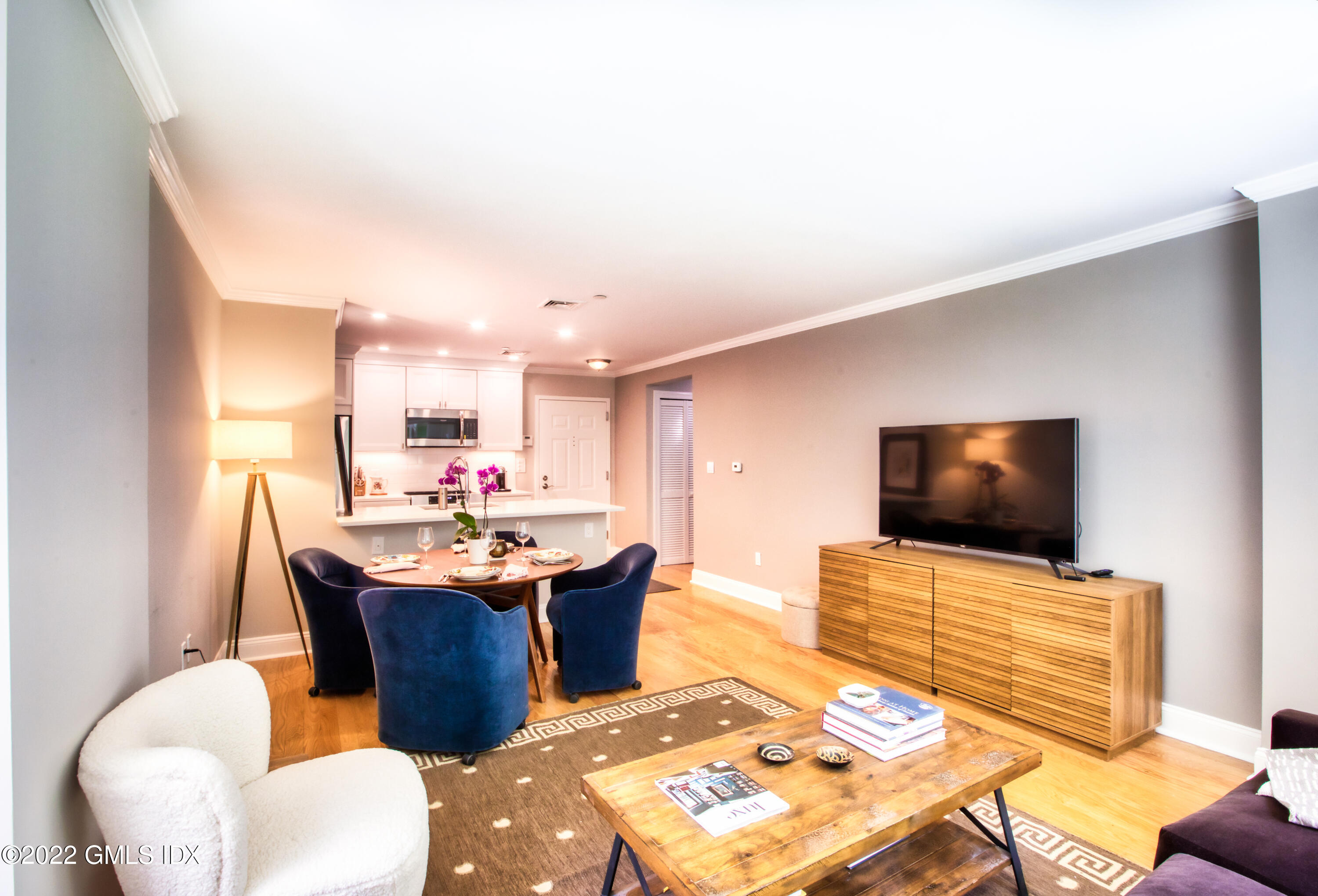 2 Homestead Lane, Unit 106 Greenwich, CT 06831 - Photo 7 of 25 a living room with dining room and flat screen tv