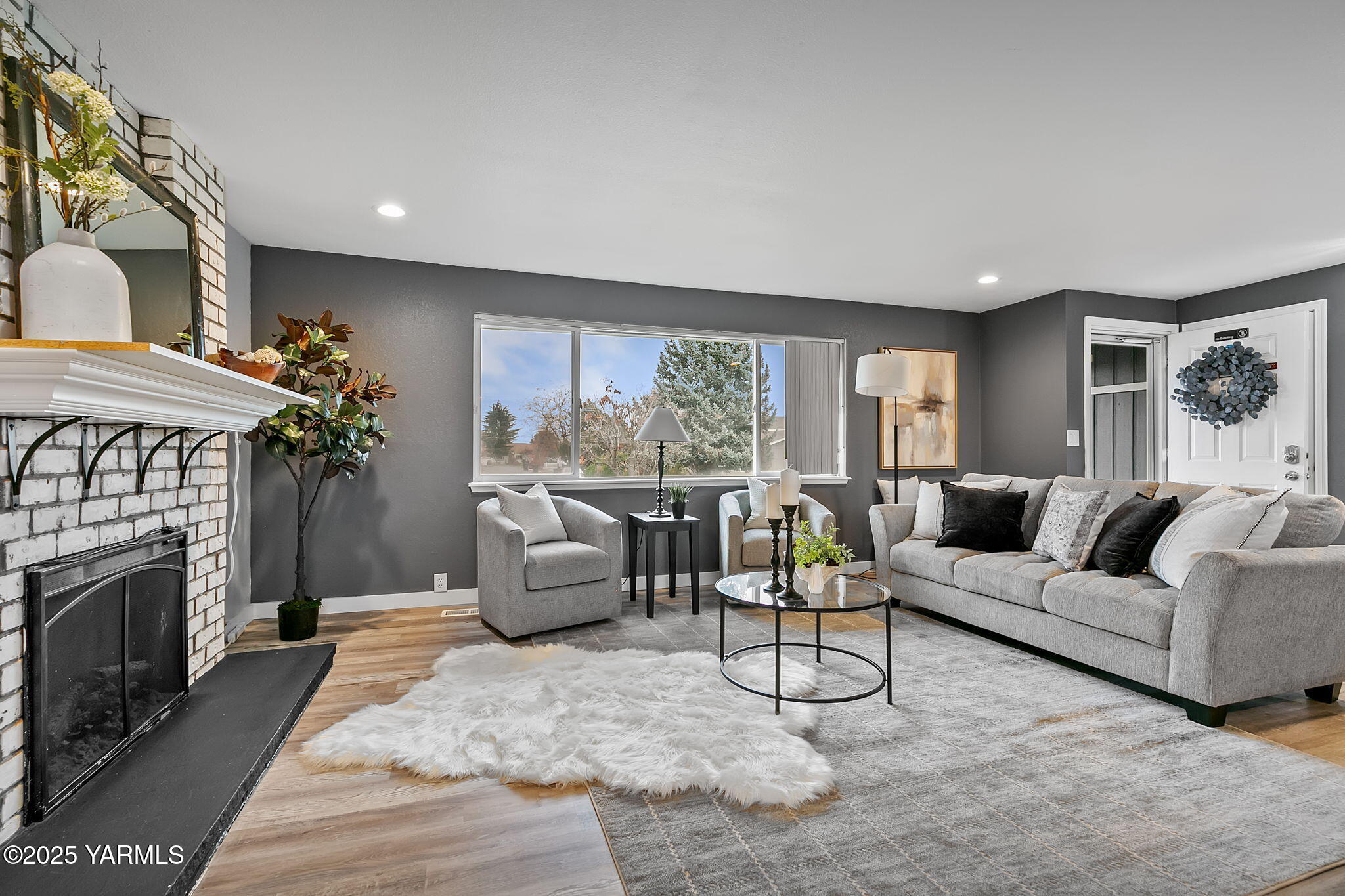 1106 South 33rd Avenue Yakima, WA 98902 - Photo 3 of 23 a living room with furniture a large window and a fireplace