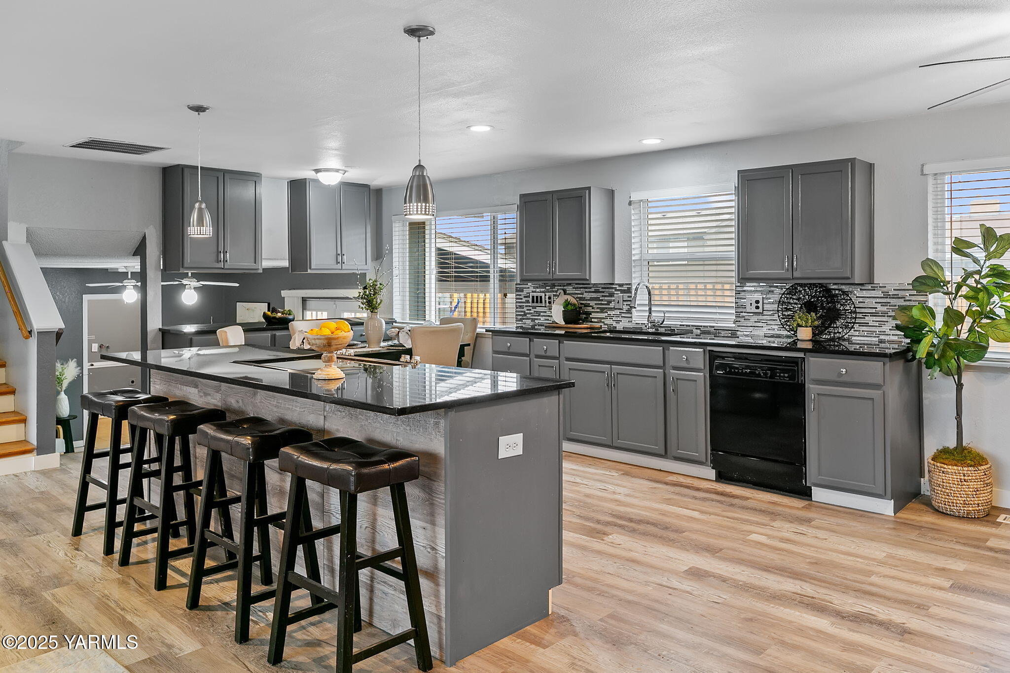 1106 South 33rd Avenue Yakima, WA 98902 - Photo 5 of 23 a kitchen with a sink a stove cabinets and wooden floor