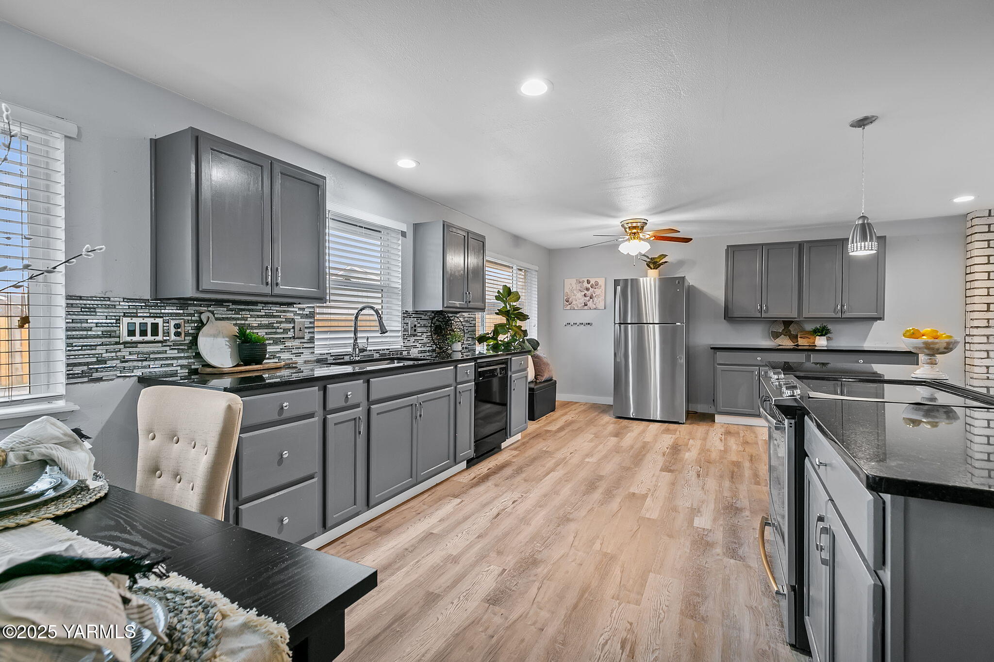 1106 South 33rd Avenue Yakima, WA 98902 - Photo 7 of 23 a kitchen with stainless steel appliances granite countertop a sink refrigerator and cabinets