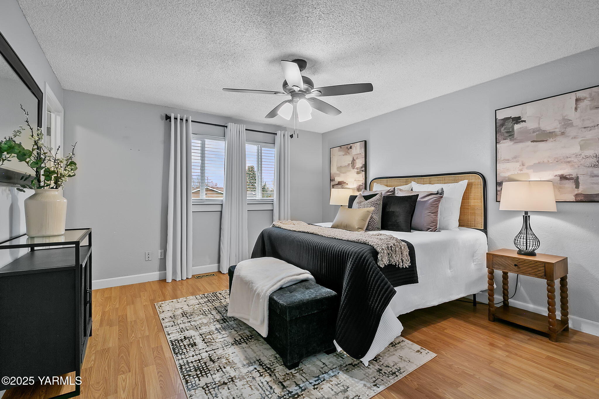 1106 South 33rd Avenue Yakima, WA 98902 - Photo 9 of 23 a bedroom with a bed and wooden floor
