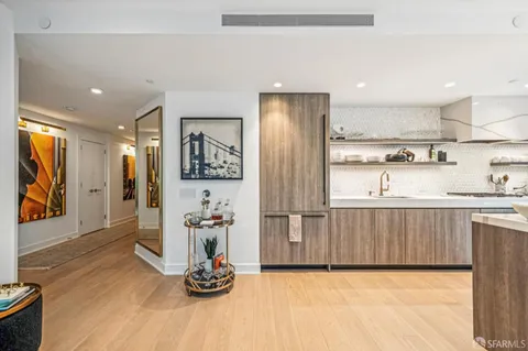 a dining room with glass top table and chairs