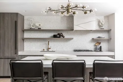 a kitchen with stainless steel appliances a sink and cabinets