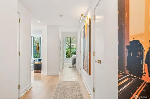 a room that has a table and a chair with wooden floor