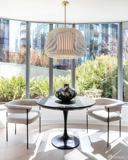 a living room with furniture and a floor to ceiling window