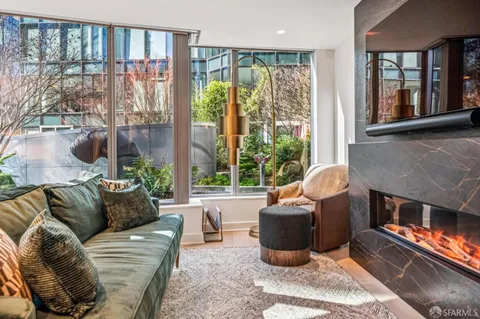 a living room with furniture and a floor to ceiling window