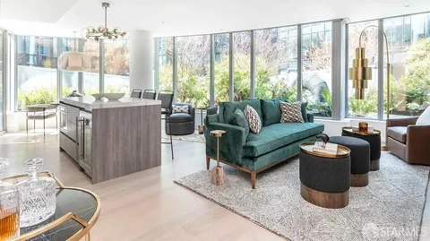 a living room with furniture and a floor to ceiling window