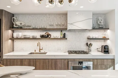 a kitchen with stainless steel appliances kitchen island granite countertop a sink and cabinets