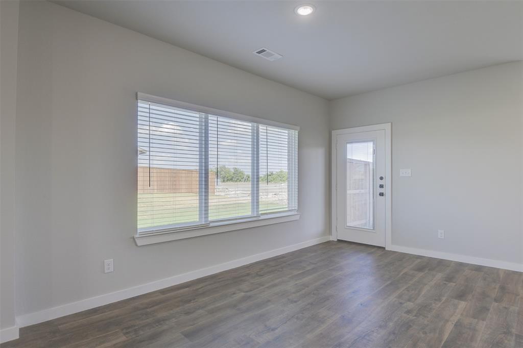 4240 Clovis Street Midlothian, TX 76065 - Photo 5 of 19 an empty room with wooden floor and windows
