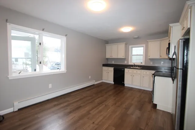 a kitchen with a refrigerator and window