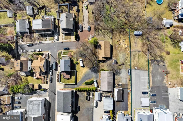 a living room with a book shelf and a dining table