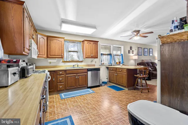 a living room with furniture and a ceiling fan