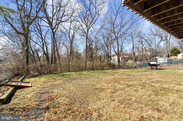 a view of a house with a small yard and sitting area