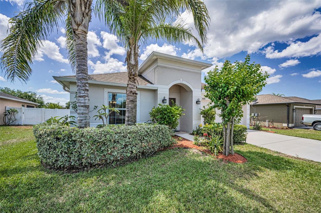 10106 Tolman Drive Hudson, FL 34667 - Photo 2 of 66 a front view of a house with a yard and garage