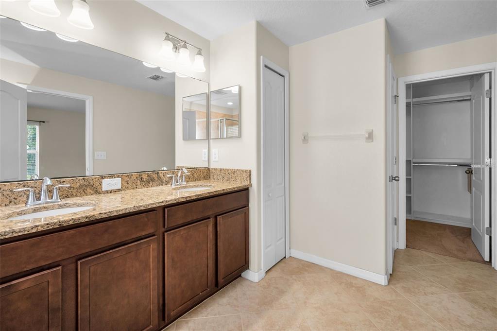 10106 Tolman Drive Hudson, FL 34667 - Photo 23 of 66 a bathroom with a double vanity sink and mirror