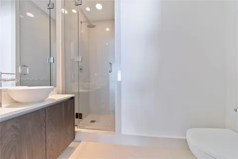 a living room with furniture a flat screen tv and a large window