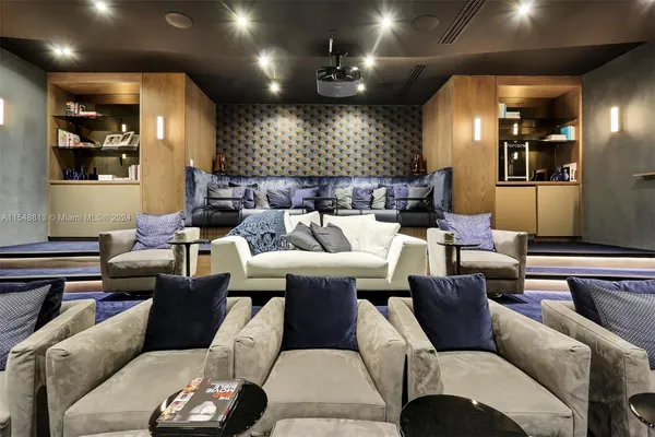 a living room with furniture a rug and a flat screen tv