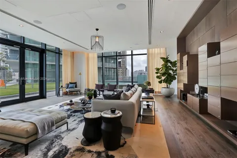 a living room with furniture a dining table and chairs with wooden floor