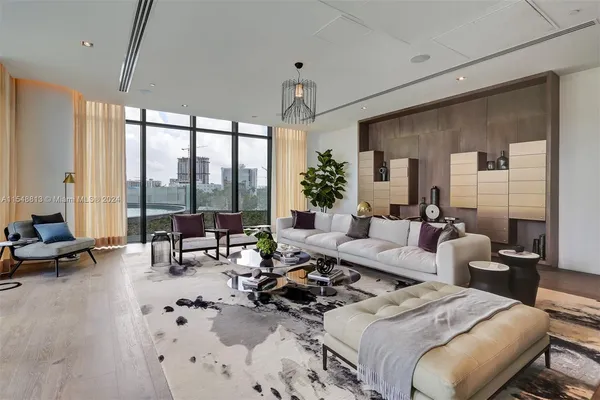 a living room filled with furniture and a chandelier