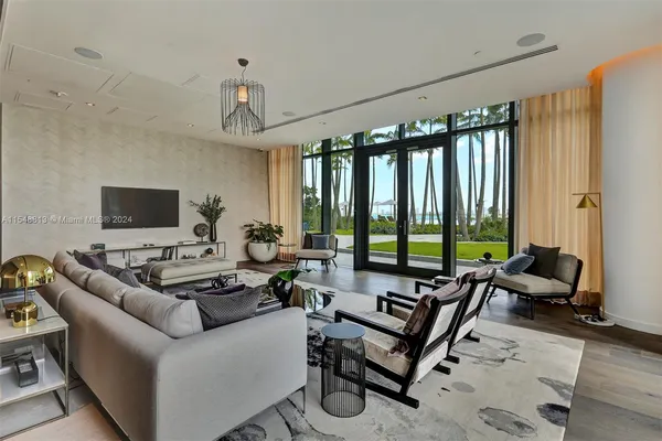 a living room with furniture and view of kitchen