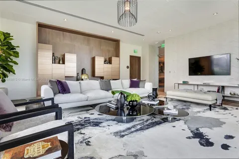 a living room with furniture a table and a potted plant