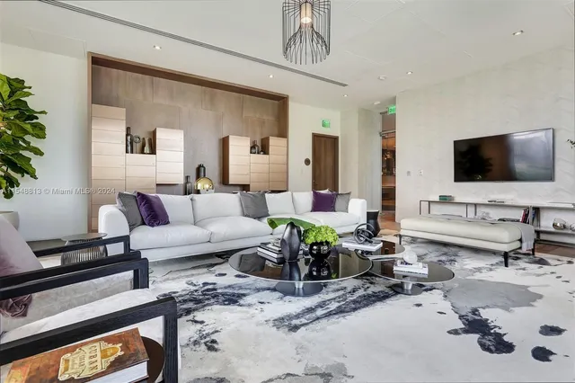 a living room with furniture a table and a potted plant