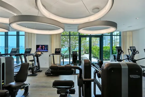 a front view of a house with a yard and fountain