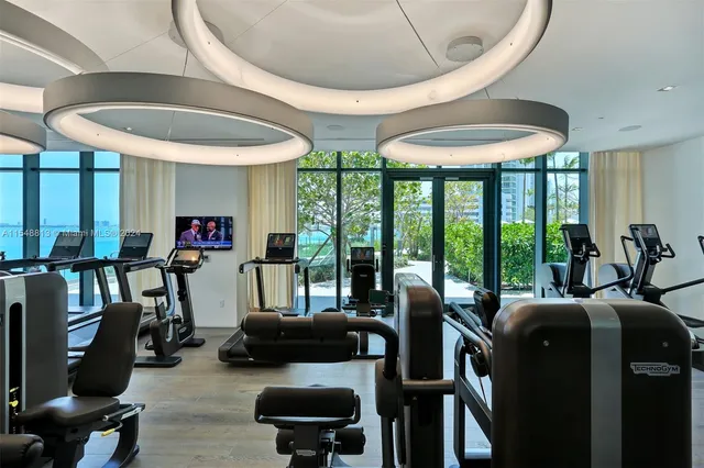 a front view of a house with a yard and fountain