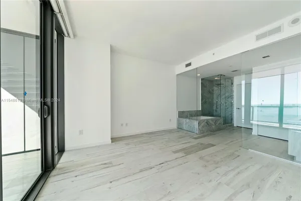 a bathroom with a sink a mirror and a shower