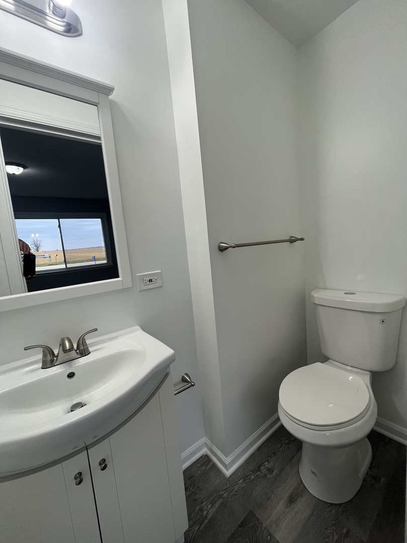 46 North 46th Road Mendota, IL 61342 - Photo 14 of 48 a bathroom with a toilet sink and mirror