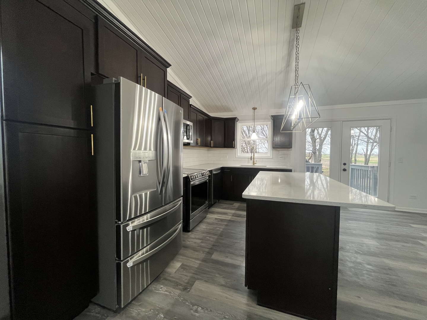 46 North 46th Road Mendota, IL 61342 - Photo 6 of 48 a kitchen with kitchen island a counter top space a refrigerator and cabinets