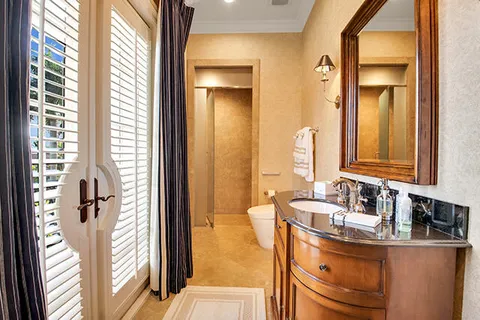 a spacious bedroom with a bed and a chandelier