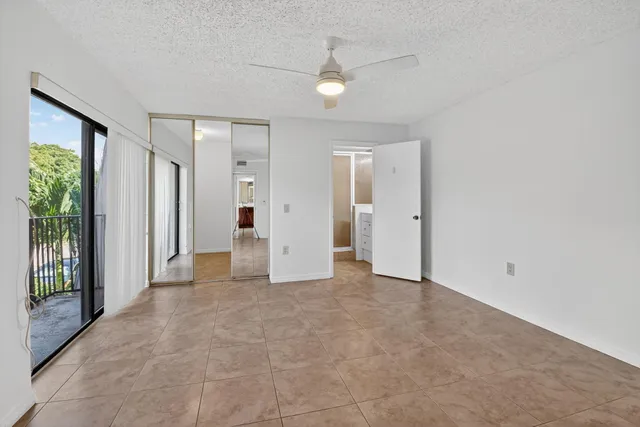 a bathroom with a granite countertop sink a toilet and a shower