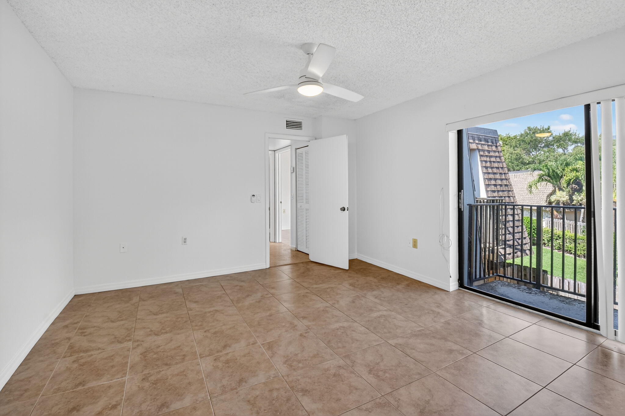 2907 Southwest 22nd Circle, Unit 39D Delray Beach, FL 33445 - Photo 19 of 57 a view of an empty room with glass door