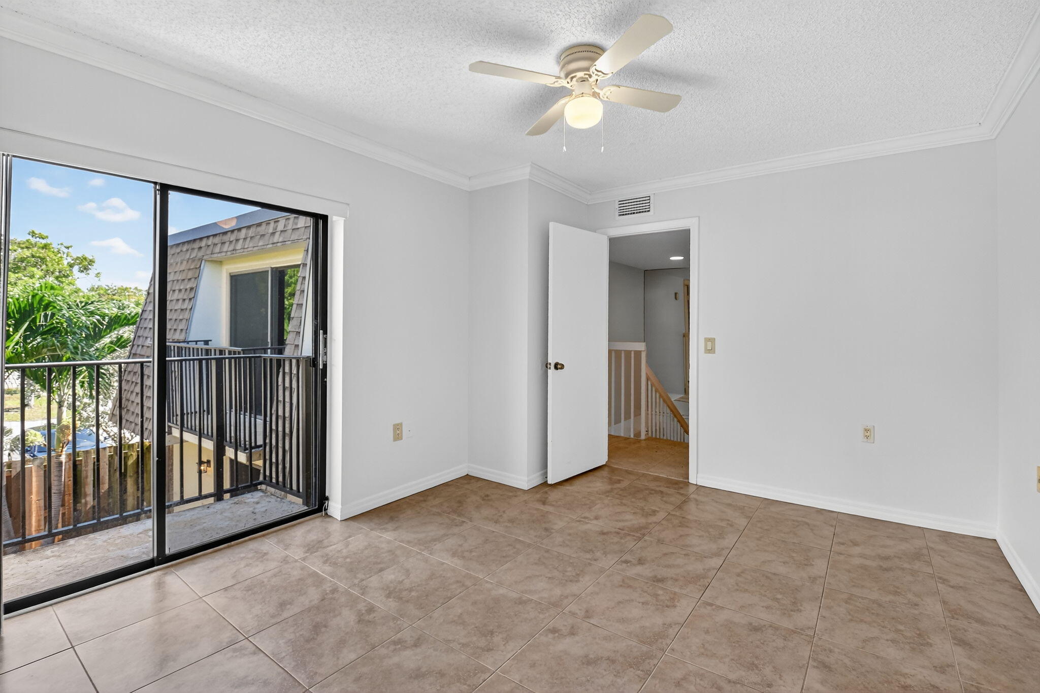 2907 Southwest 22nd Circle, Unit 39D Delray Beach, FL 33445 - Photo 23 of 57 an empty room with fan and windows
