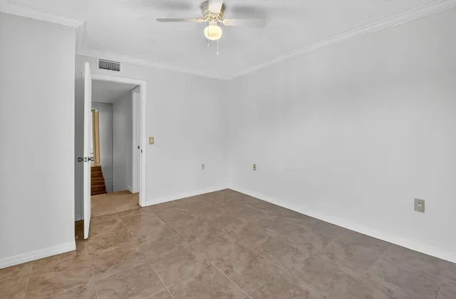 a view of a brick house with a iron gate