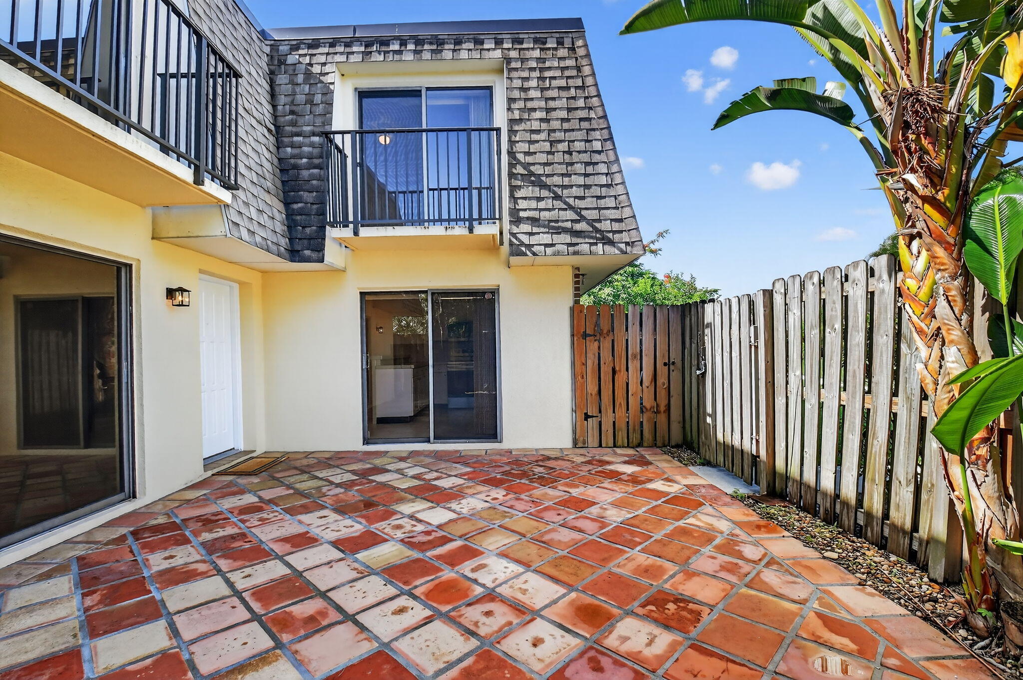 2907 Southwest 22nd Circle, Unit 39D Delray Beach, FL 33445 - Photo 31 of 57 a view of a brick house with a iron gate