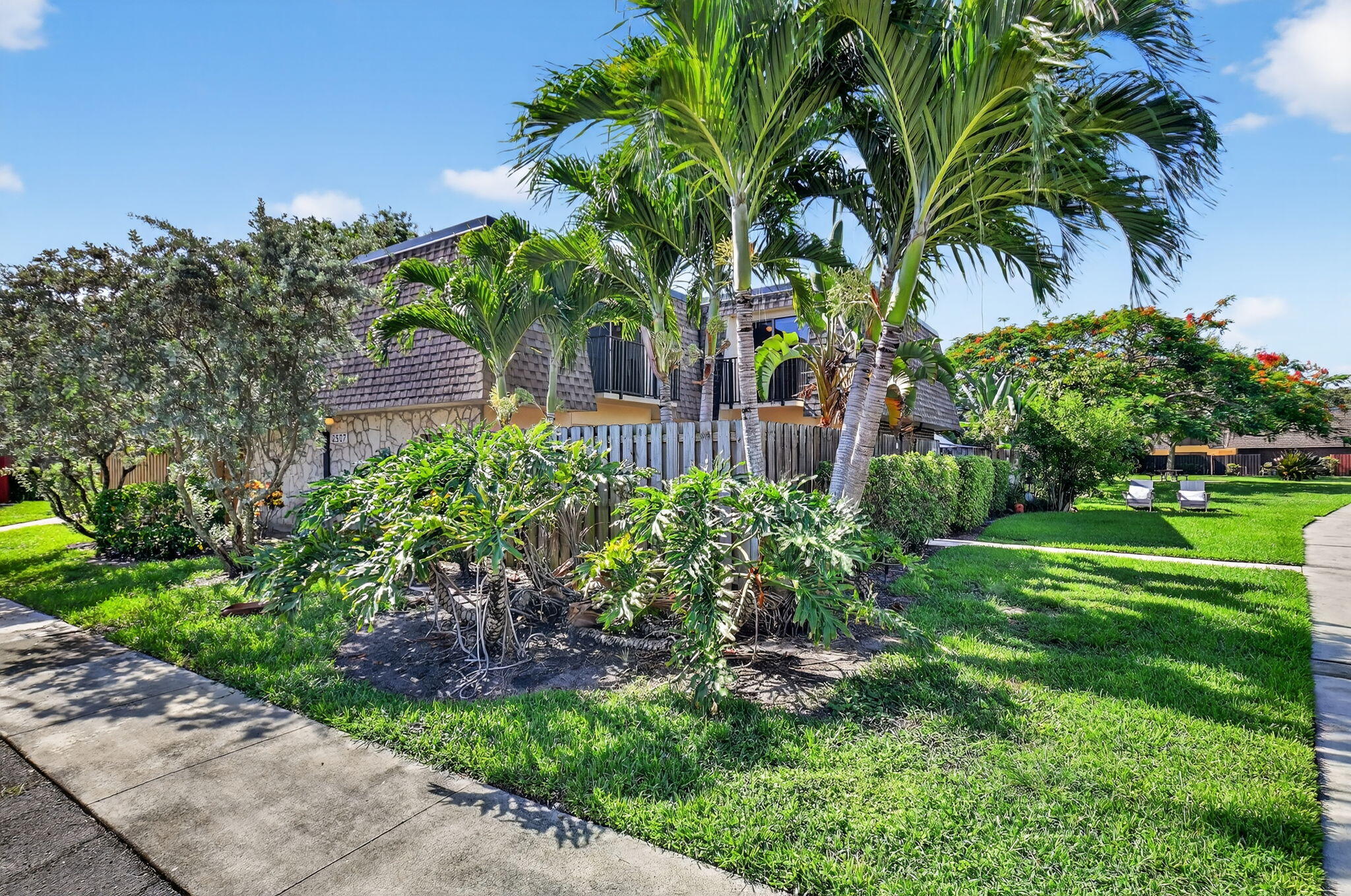 2907 Southwest 22nd Circle, Unit 39D Delray Beach, FL 33445 - Photo 33 of 57 a front view of a house with a garden
